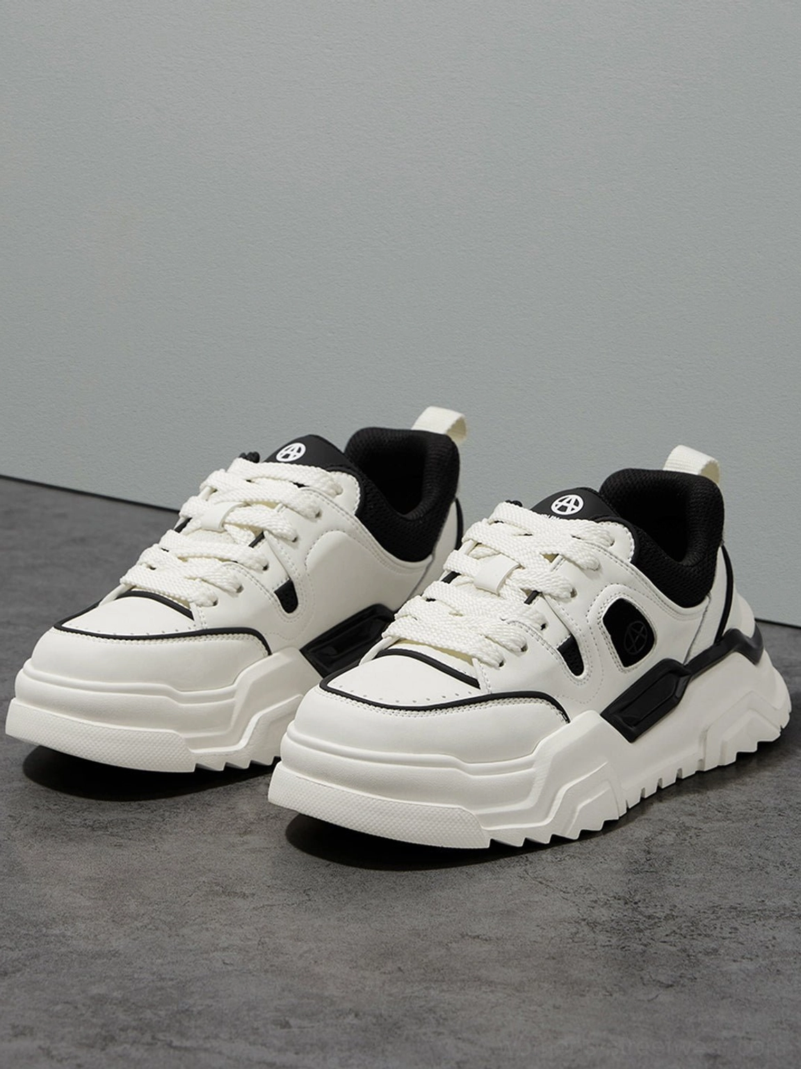 Top-down view of a pair of black and white contrast cutout platform sneakers