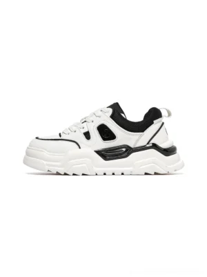 White and black contrast cutout lug sole platform sneakers shown in side profile