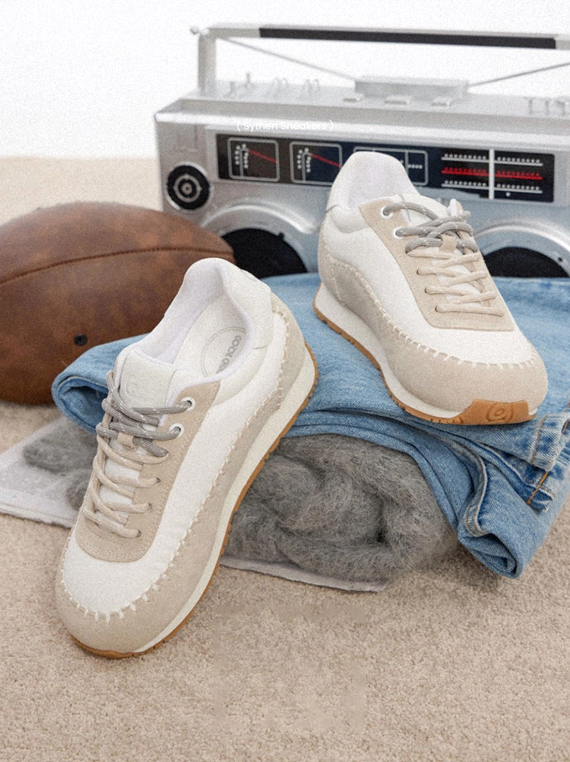 Contrast-stitch platform sneakers featuring a low-top silhouette, rounded toe, raised sole, and modern streetwear design
