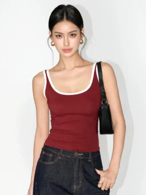 Burgundy contrast trim scoop neck ribbed knit tank top styled with dark wash jeans and a black shoulder bag