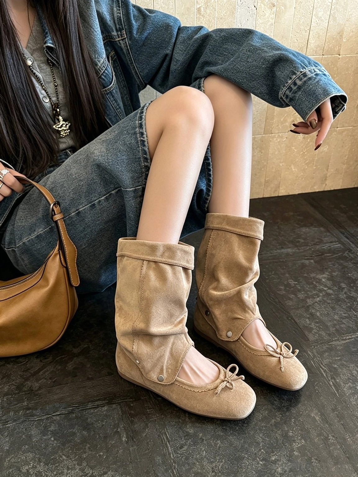 Apricot convertible bow-wrap slouchy sandal boots worn with denim outfit and tan handbag in studio close-up