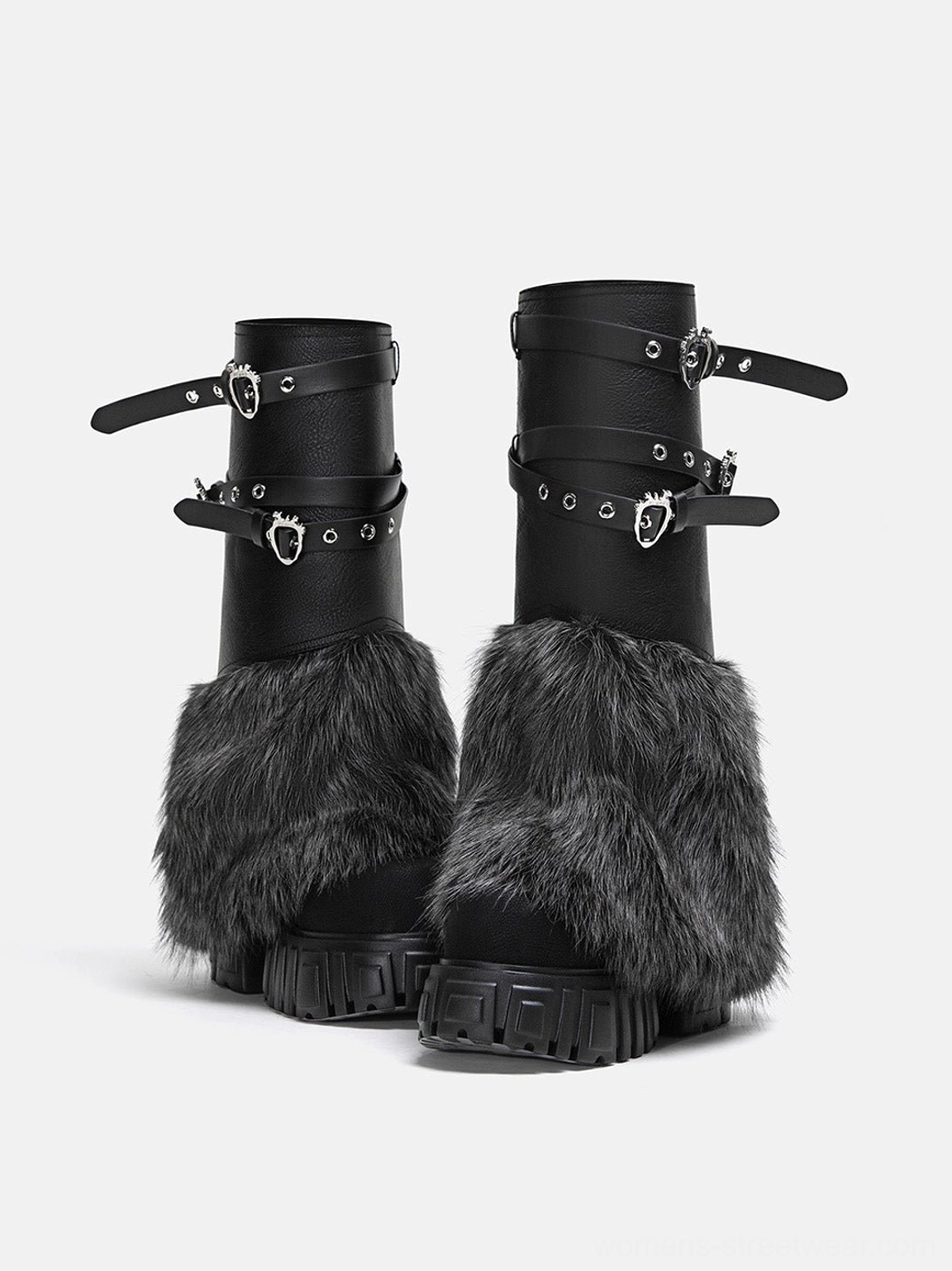 Front product view of black faux fur platform boots featuring heart-shaped metal buckles, adjustable straps and lug sole