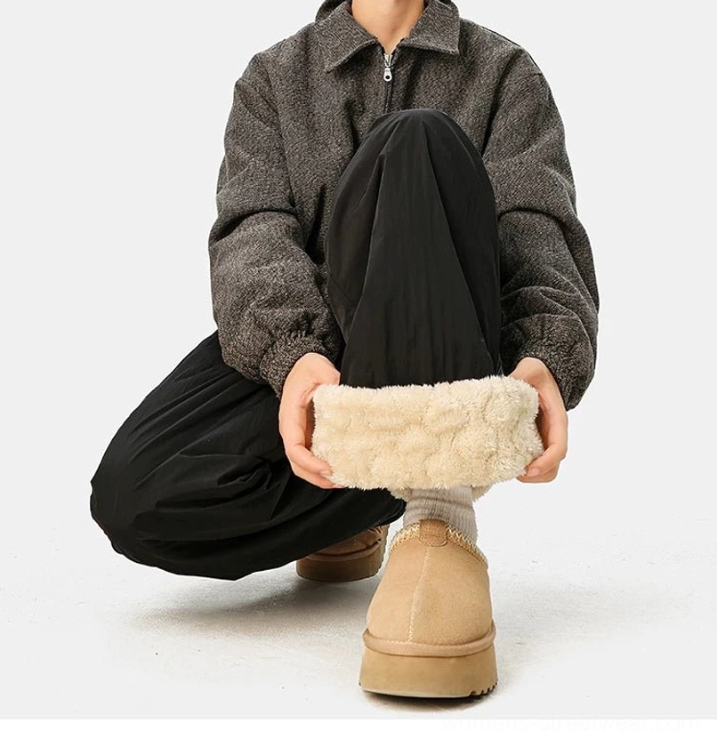Convertible wide-leg streetwear pants showing the crinkled polyester outer shell and relaxed cold-weather silhouette