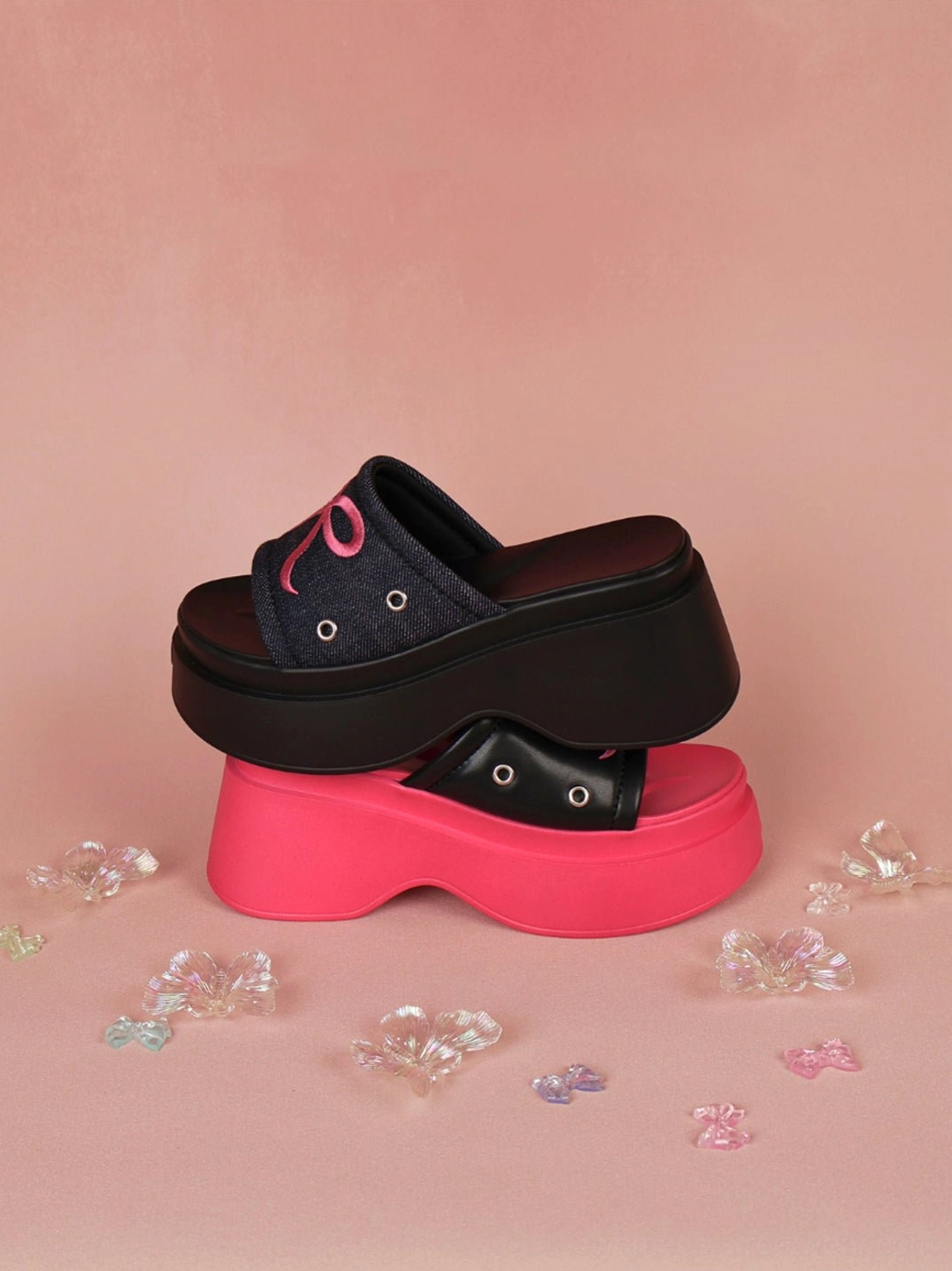 Playful coquette and punk-inspired bow platform slide sandals in hot pink and black