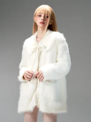 Ivory loose shaggy cardigan jacket worn closed in studio showing button front and decorative pocket trim