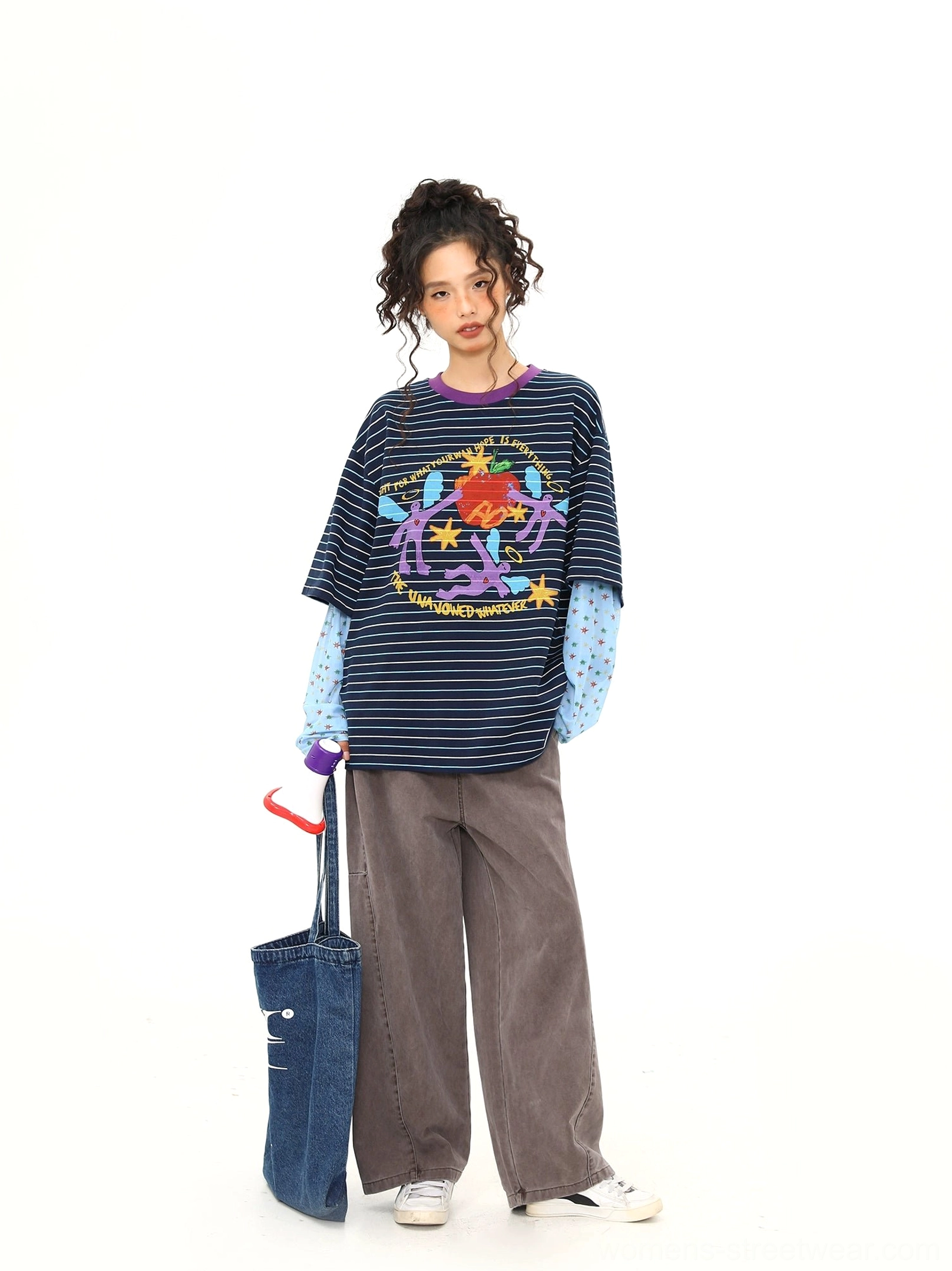 Blue striped cartoon graphic long sleeve streetwear shirt shown from the side with relaxed oversized fit, wide leg trousers, and denim tote bag