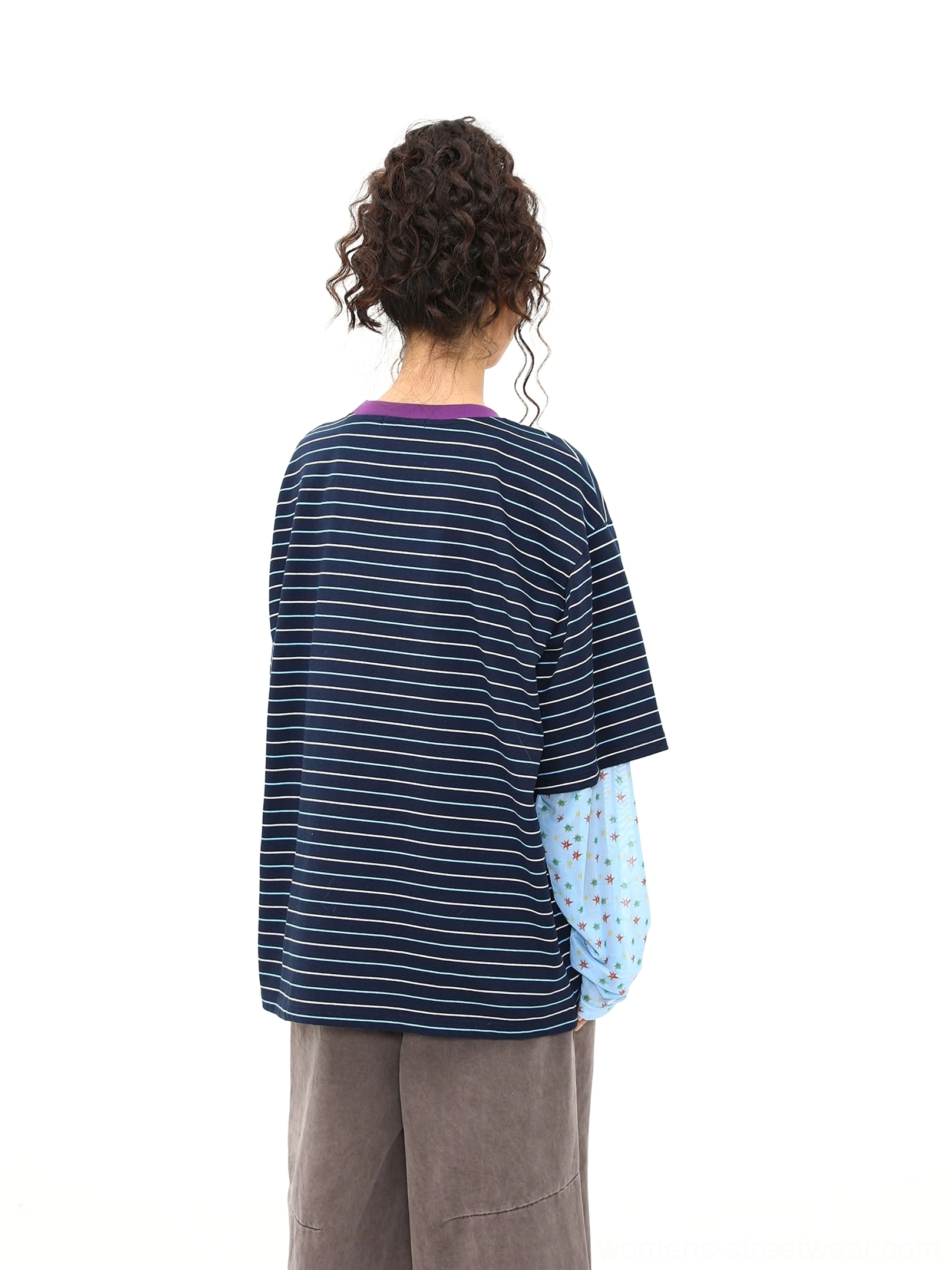 Back view of blue striped fake two-piece long sleeve streetwear tee showing horizontal stripe pattern, relaxed oversized shape, and layered sleeve cuffs