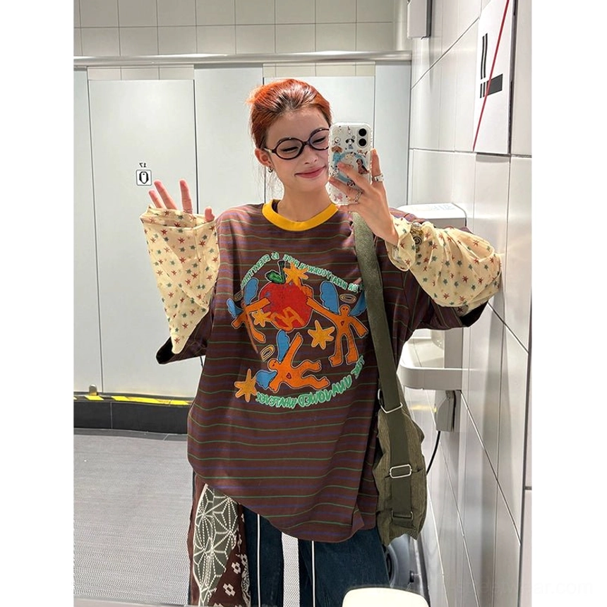 Brown striped graphic long sleeve streetwear tee with colorful retro cartoon chest print, yellow contrast collar, beige polka dot inner sleeves, and crossbody styling