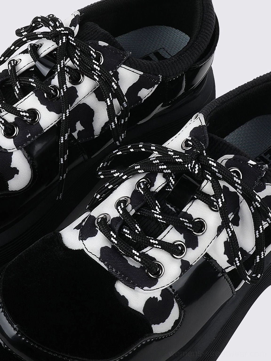 Cow print platform Mary Jane streetwear shoes featuring a graphic textile upper, rounded toe, side buckle, and thick black sole