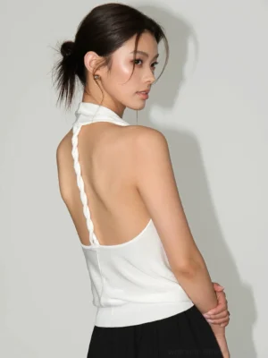 Off white backless braided halter top showing twisted strap detail and fitted East Asian streetwear design