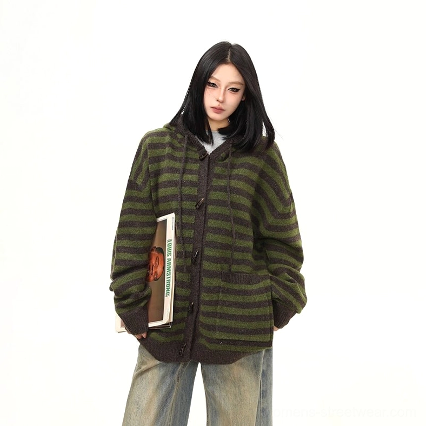 Three-quarter front view of a cozy oversized striped toggle knit hoodie cardigan styled with hands in pockets and casual streetwear layers