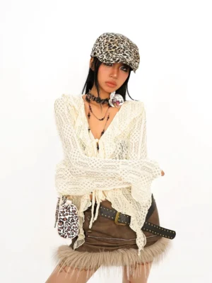 Front close-up of women cream boho crochet tie-front ruffle top with sheer open-knit texture and flared long sleeves