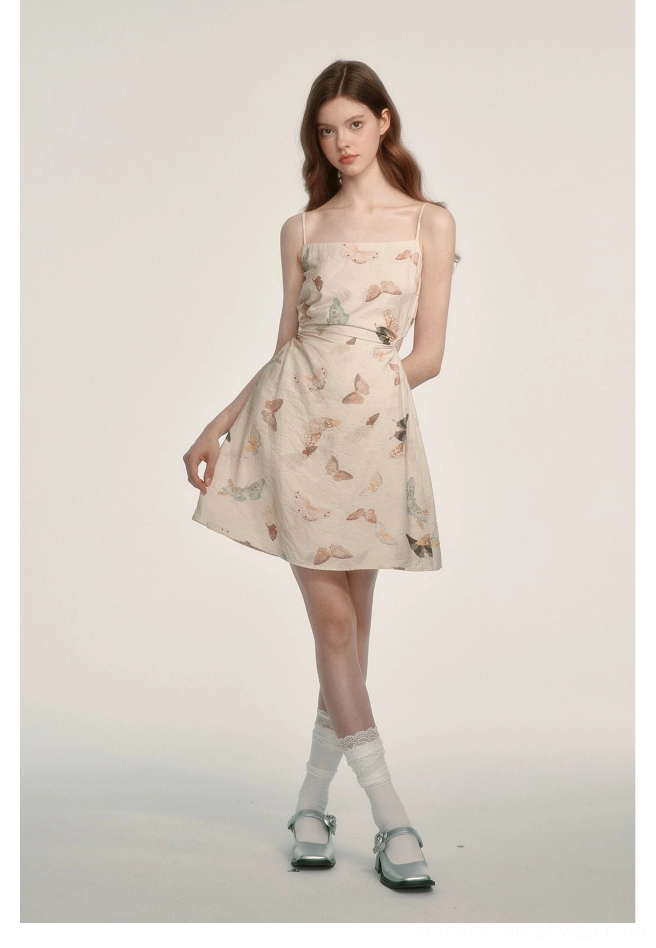 Side view of a cream pastel butterfly print mini dress with square neck spaghetti straps and waist-cinched silhouette