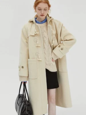 Cream white hooded duffle coat side view model wearing turtleneck and mini skirt with leather tote bag