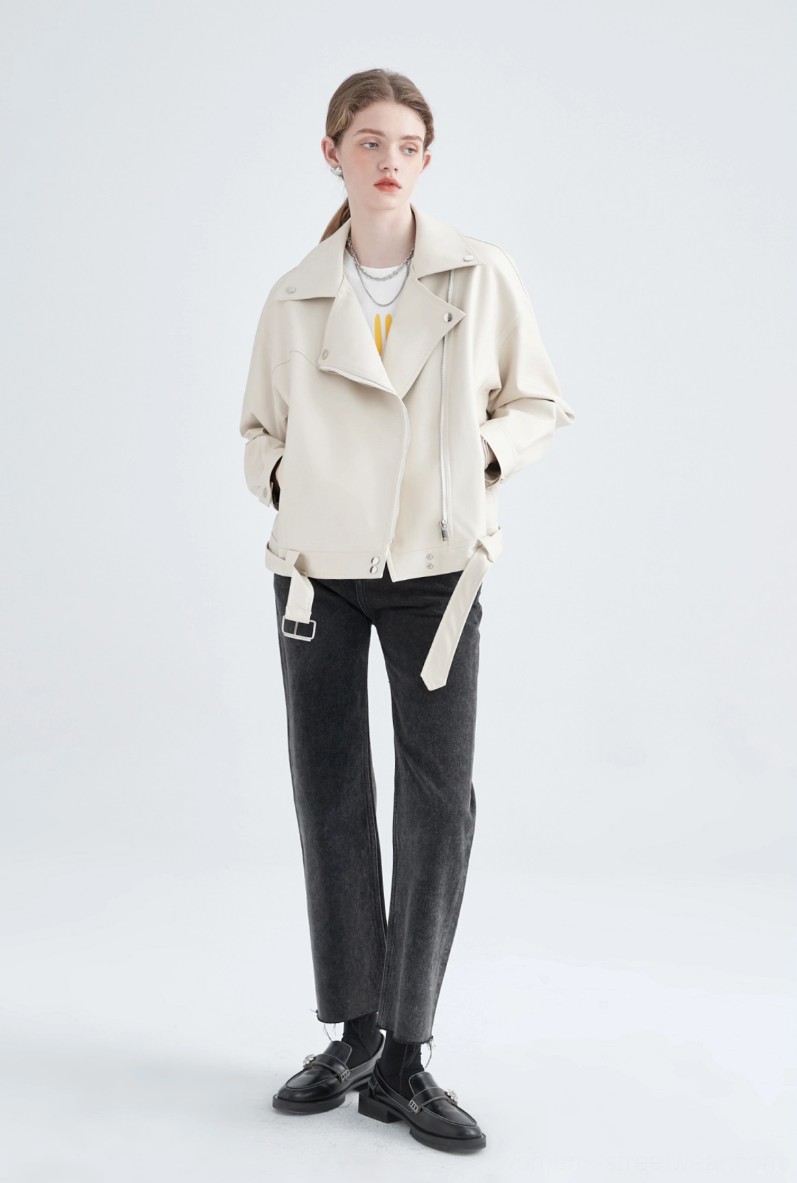 Back-side full body view of cream oversized faux leather moto jacket with cropped straight hem and belt detail