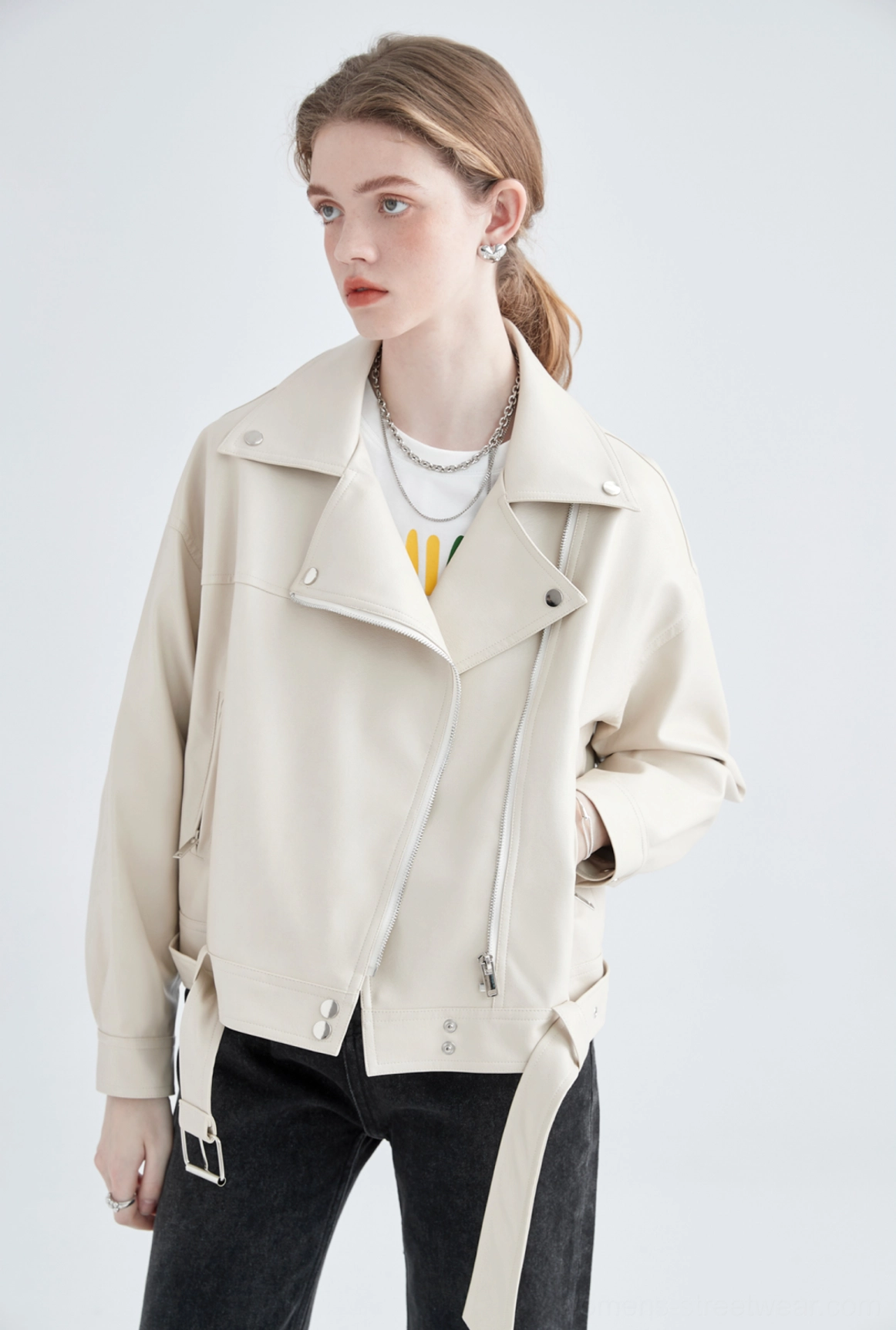Cream faux leather oversized cropped moto jacket front three-quarter view with asymmetric zipper and silver hardware