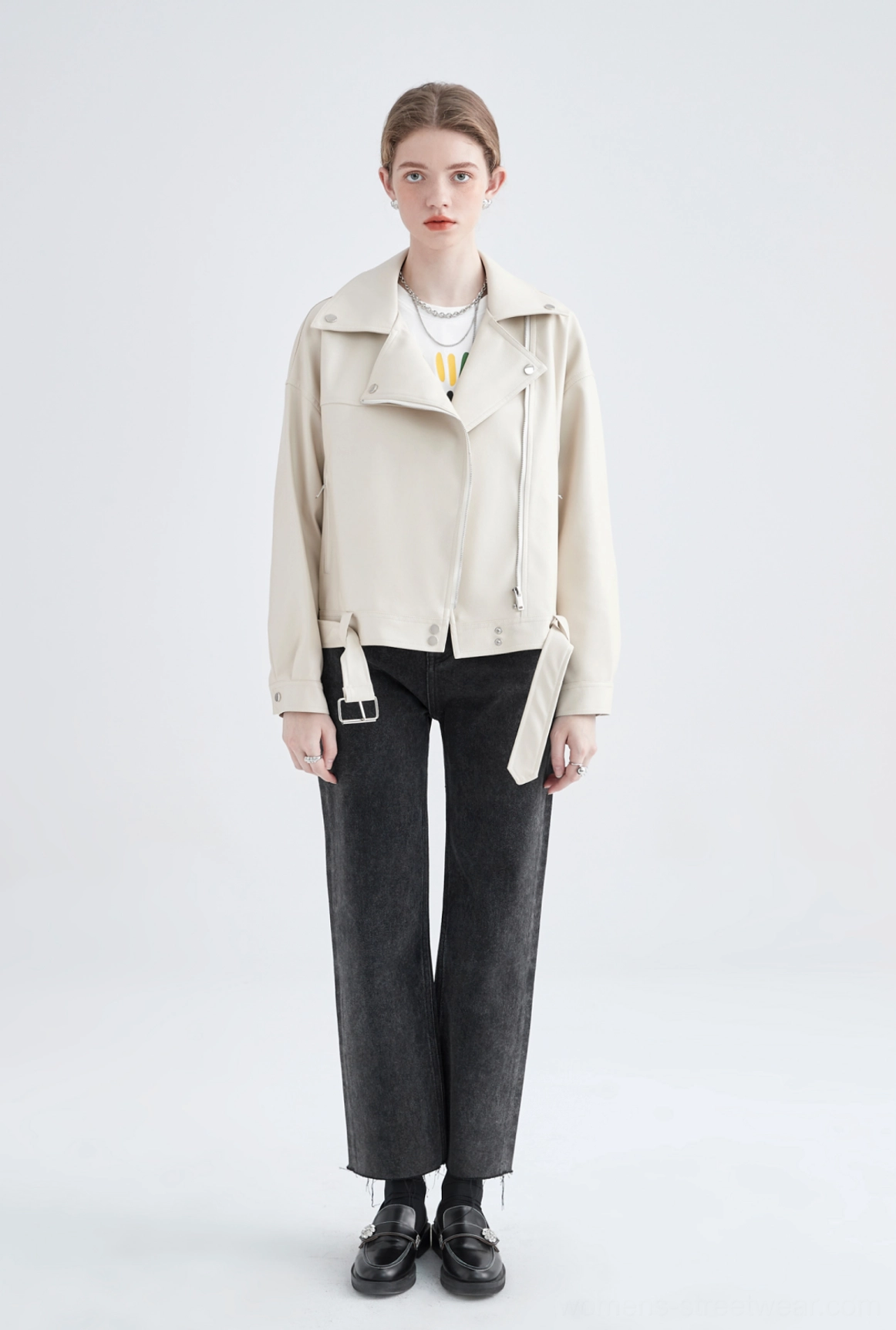 Full front studio view of cream faux leather oversized cropped biker jacket with polished silver hardware