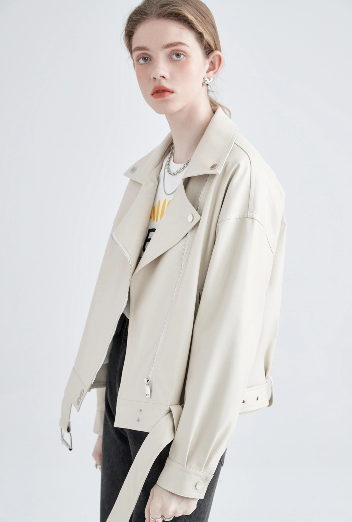 Cream faux leather moto jacket angled front view showing wide notched lapels and slanted zip pocket