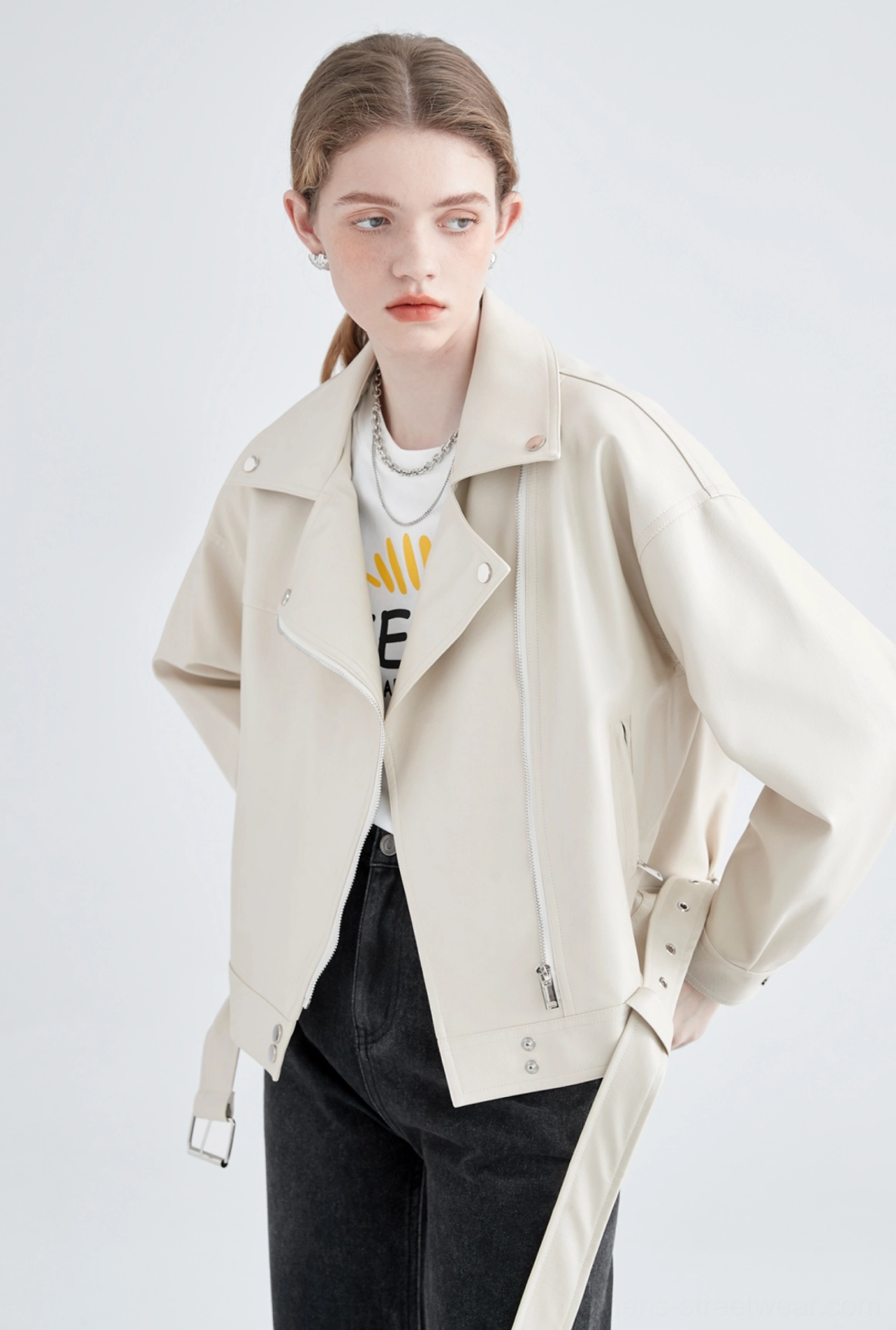 Oversized cream faux leather biker jacket front three-quarter studio view with silver zipper and belt accents