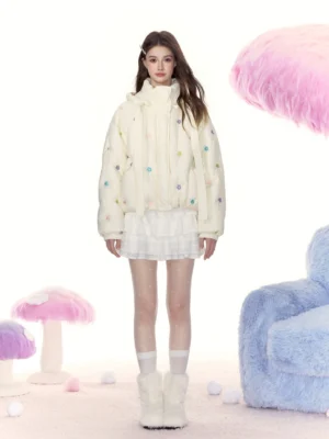 Cream floral embroidered cropped puffer jacket styled with a white mini skirt, crew socks, and fuzzy boots in a playful Korean streetwear outfit
