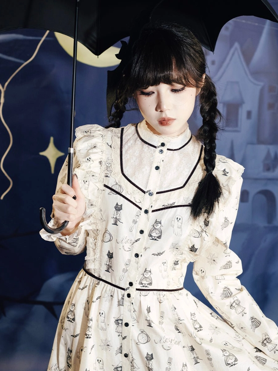 Close-up of cream ghost print Victorian Gothic Lolita dress showing lace stand collar, black ribbon trim, front placket, and spooky illustration details