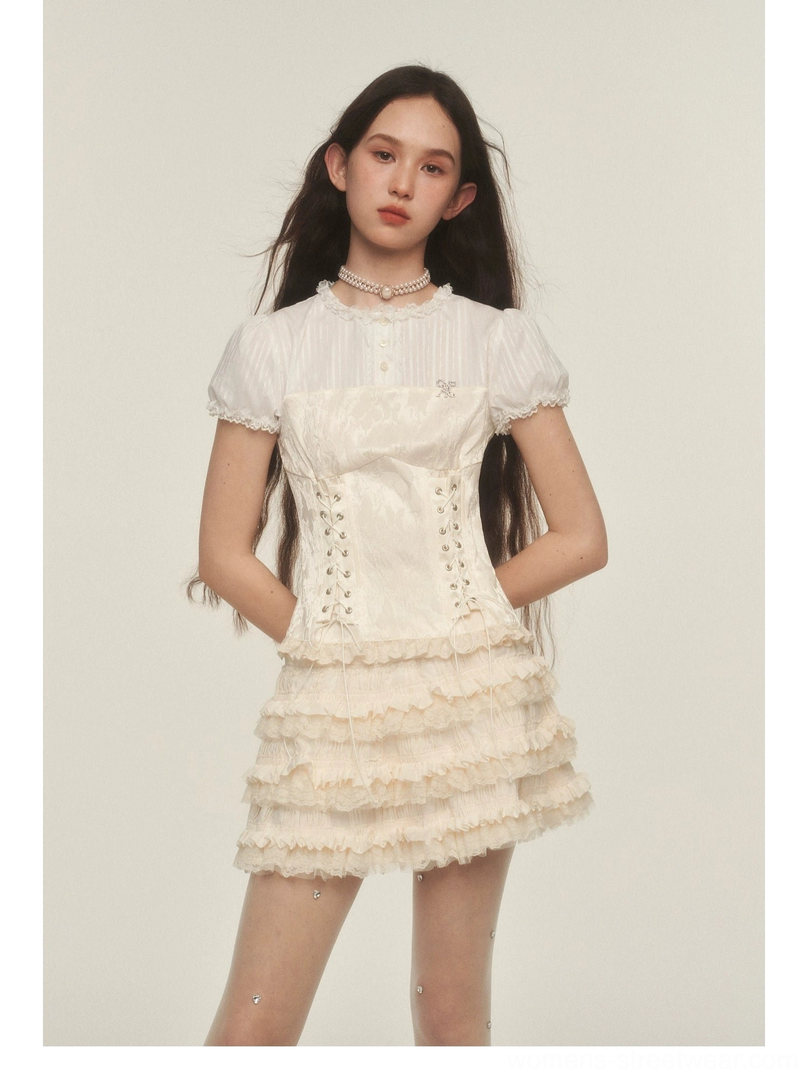 Cream high waisted ruffle mini skirt styled with a lace-up corset top and pearl choker in Korean streetwear fashion