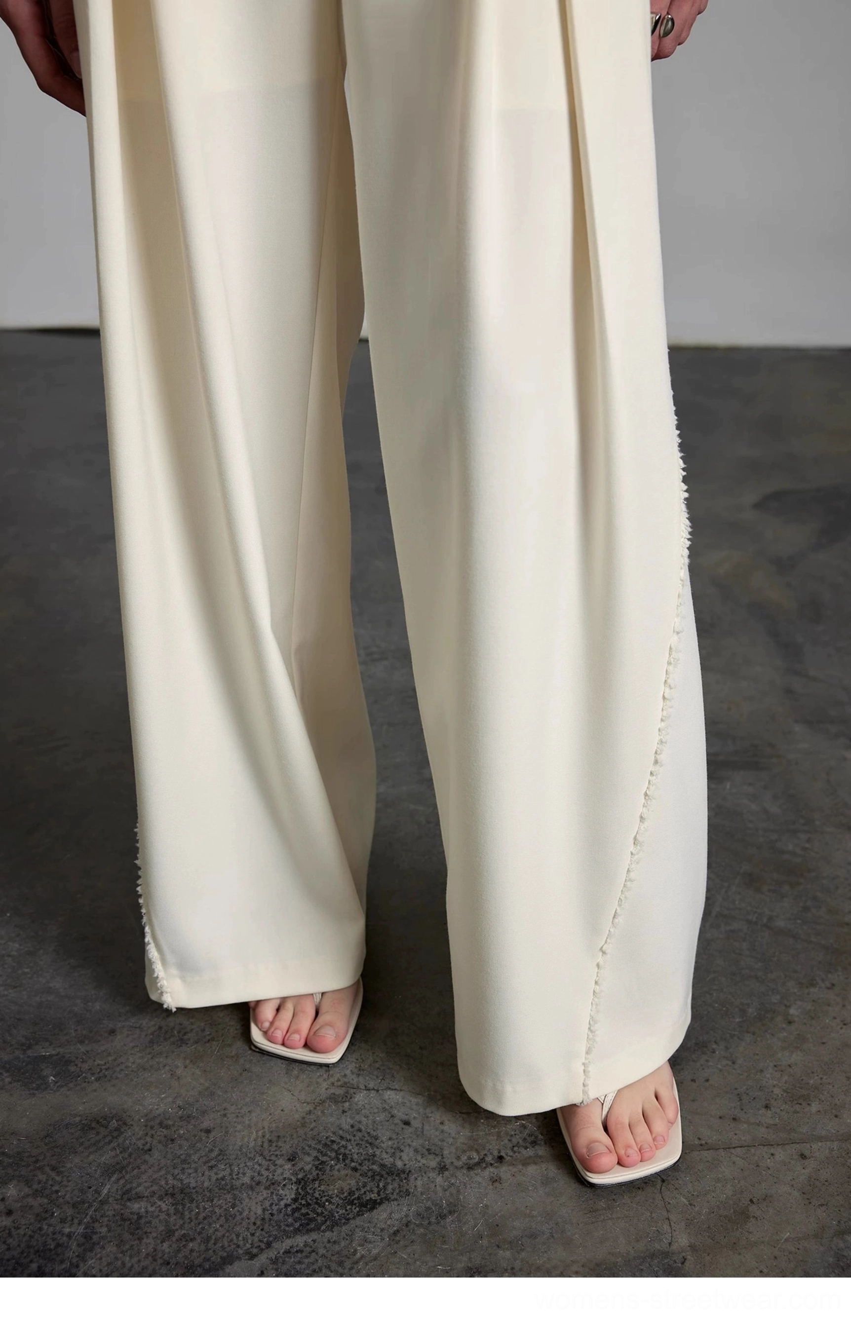 Cream high-waisted wide-leg streetwear trousers product detail view showing relaxed tailored silhouette