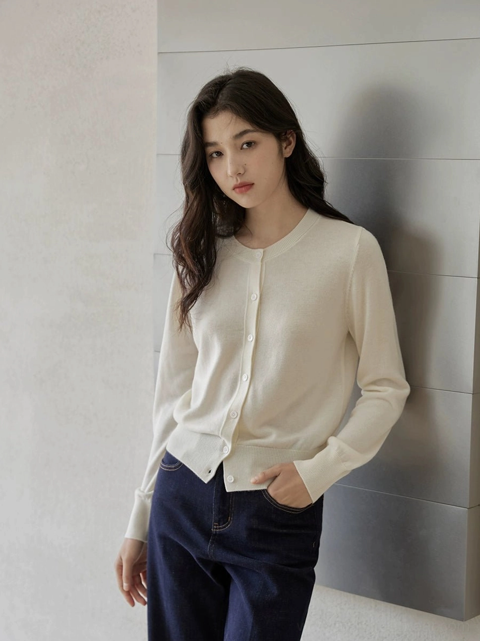 Cream ivory women's crew neck button-front cardigan with long sleeves styled over dark wide-leg jeans for minimalist Korean fashion