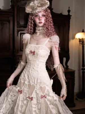 Cream lace heart cutout midi dress with dusty pink bows and sheer ruffled sleeves front three quarter view