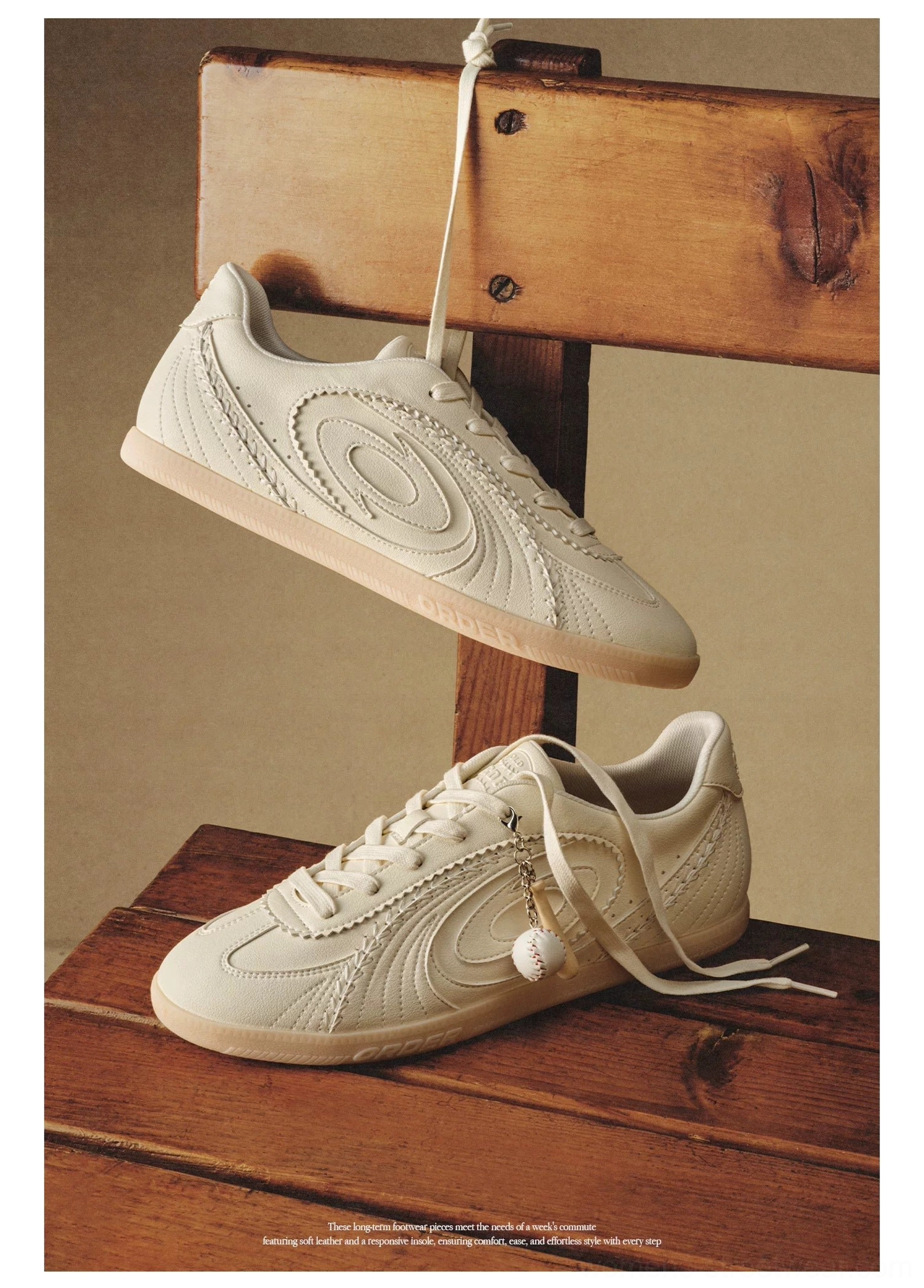 Cream vintage training sneaker hanging display with embossed oval side pattern and smooth tonal finish