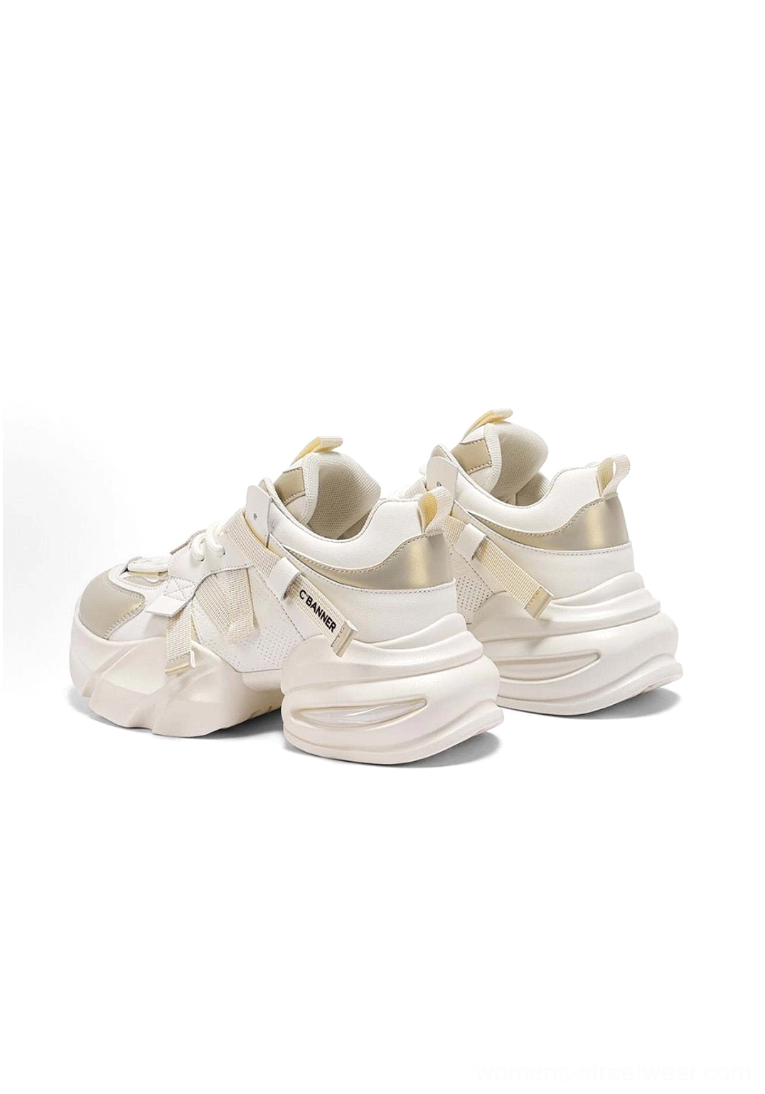 Side three-quarter view of cream white chunky sneakers showing heel tabs, stitched panels, and curved platform sole