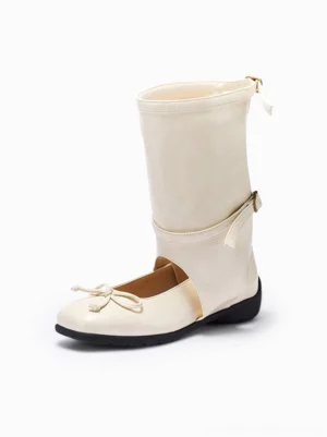 Cream white cutout mid-calf ballet boots with front bow detail, adjustable calf buckles, rear zipper, and flat black rubber sole