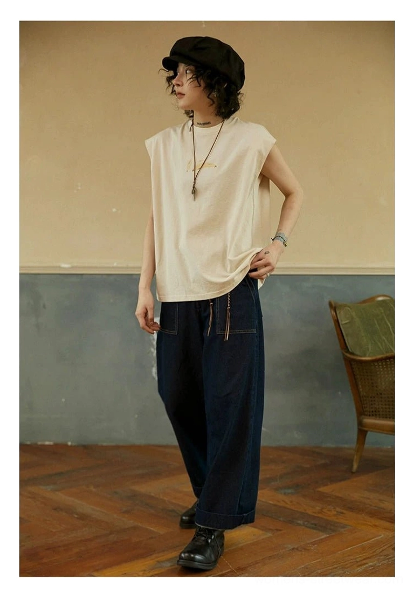 Cream White minimalist cotton sleeveless tee in three-quarter view with slightly tucked hem and relaxed crew neck