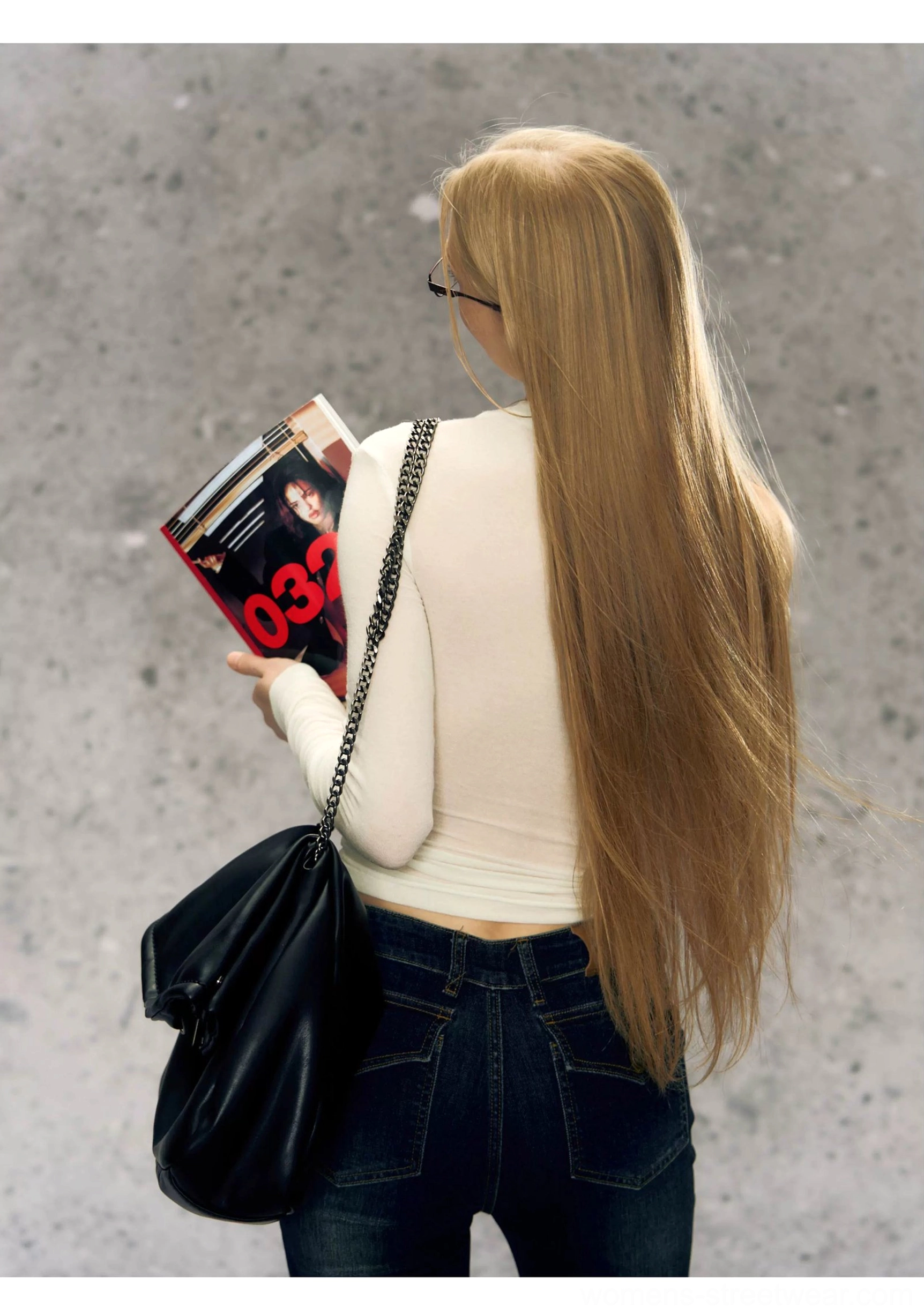 Cream white fitted one-shoulder long sleeve Korean fashion top shown from the back with dark jeans