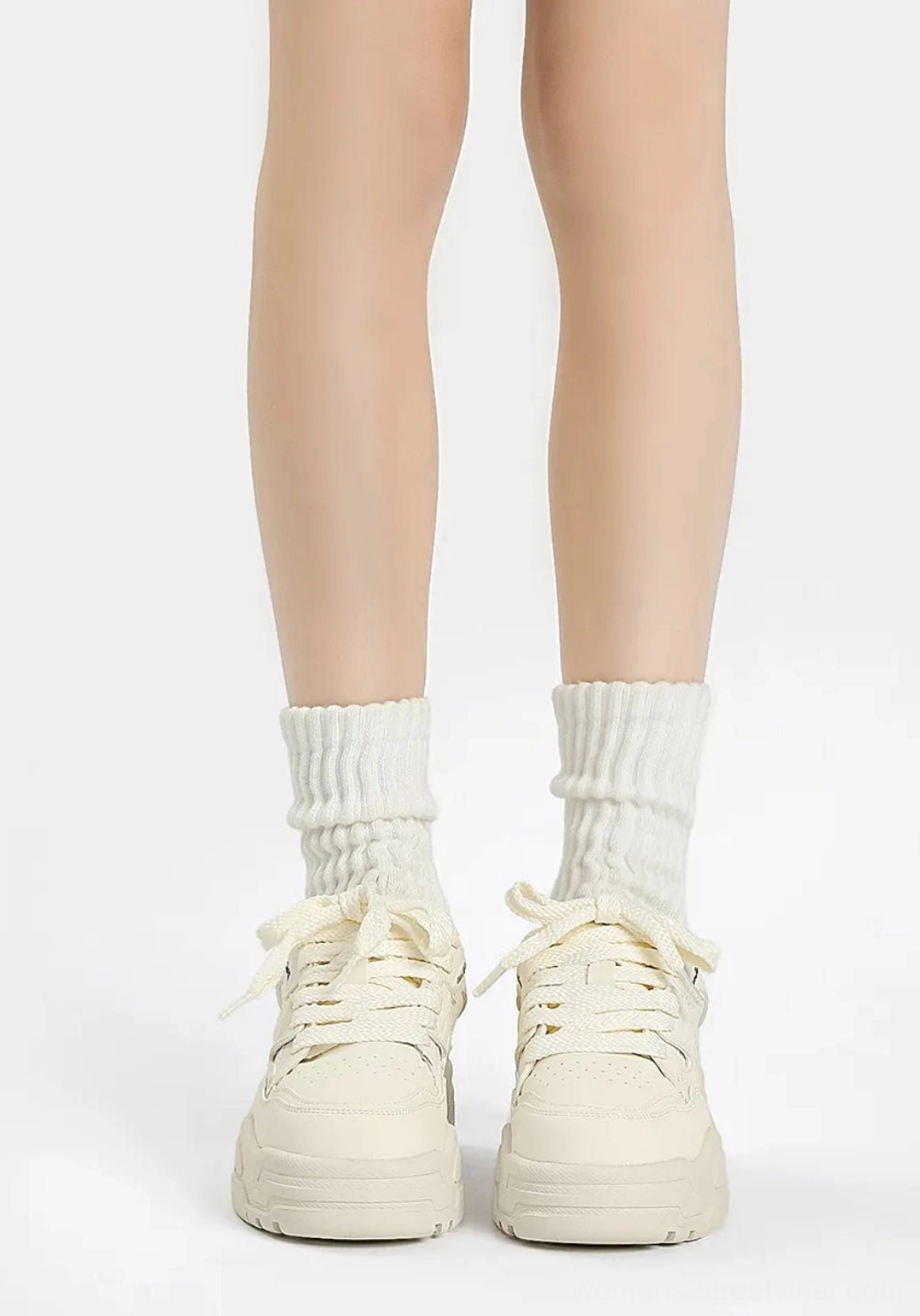 Front view of cream white platform sneakers with matching ribbed socks, classic lace-up design, and textured non-slip outsole