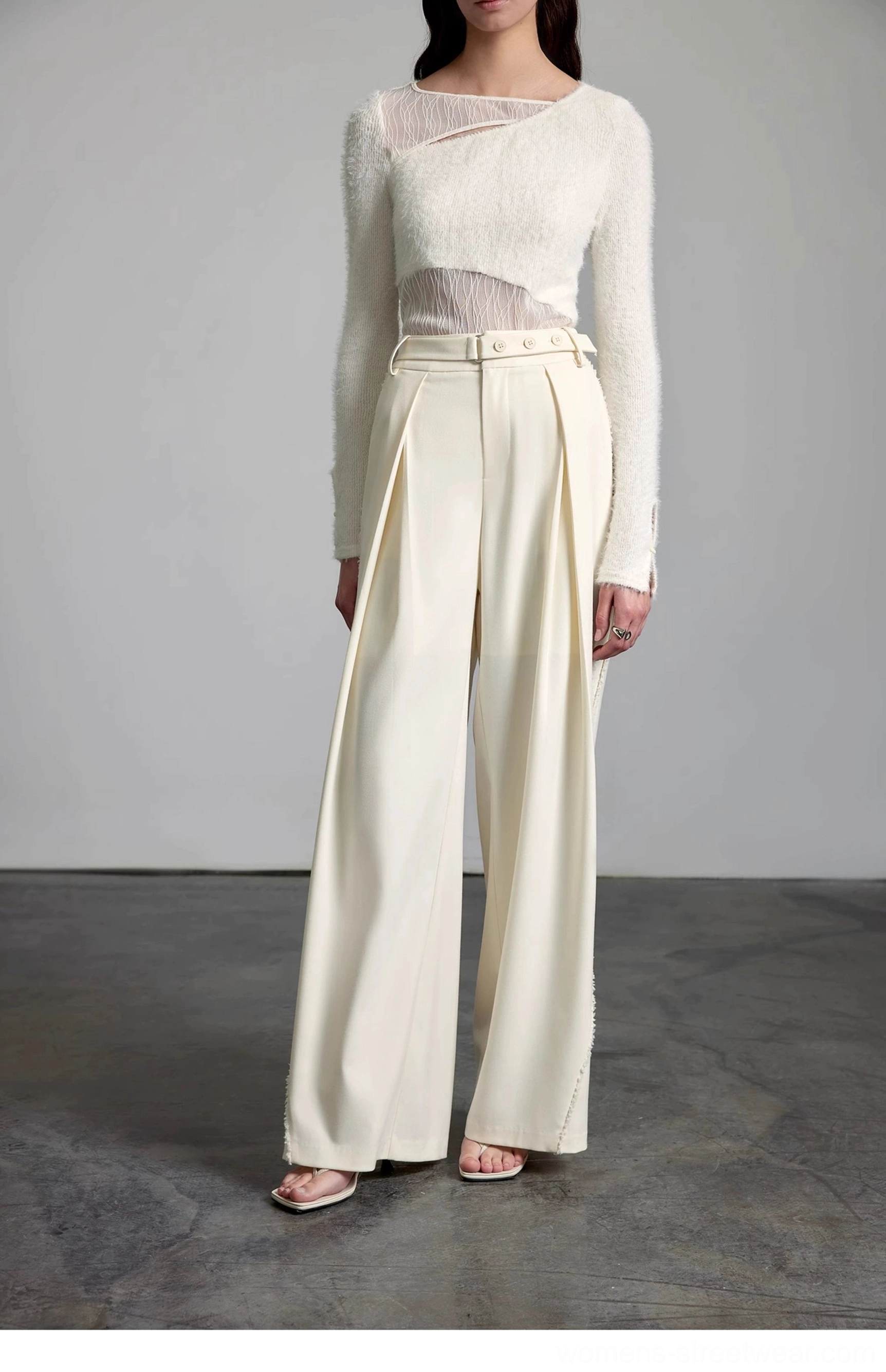 Front standing view of cream wide-leg streetwear trousers with a structured waistband and clean minimalist design