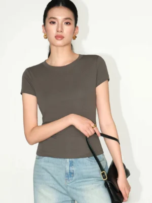 taupe gray fitted crew tee front view with light blue jeans and black leather handbag contemporary minimalist look