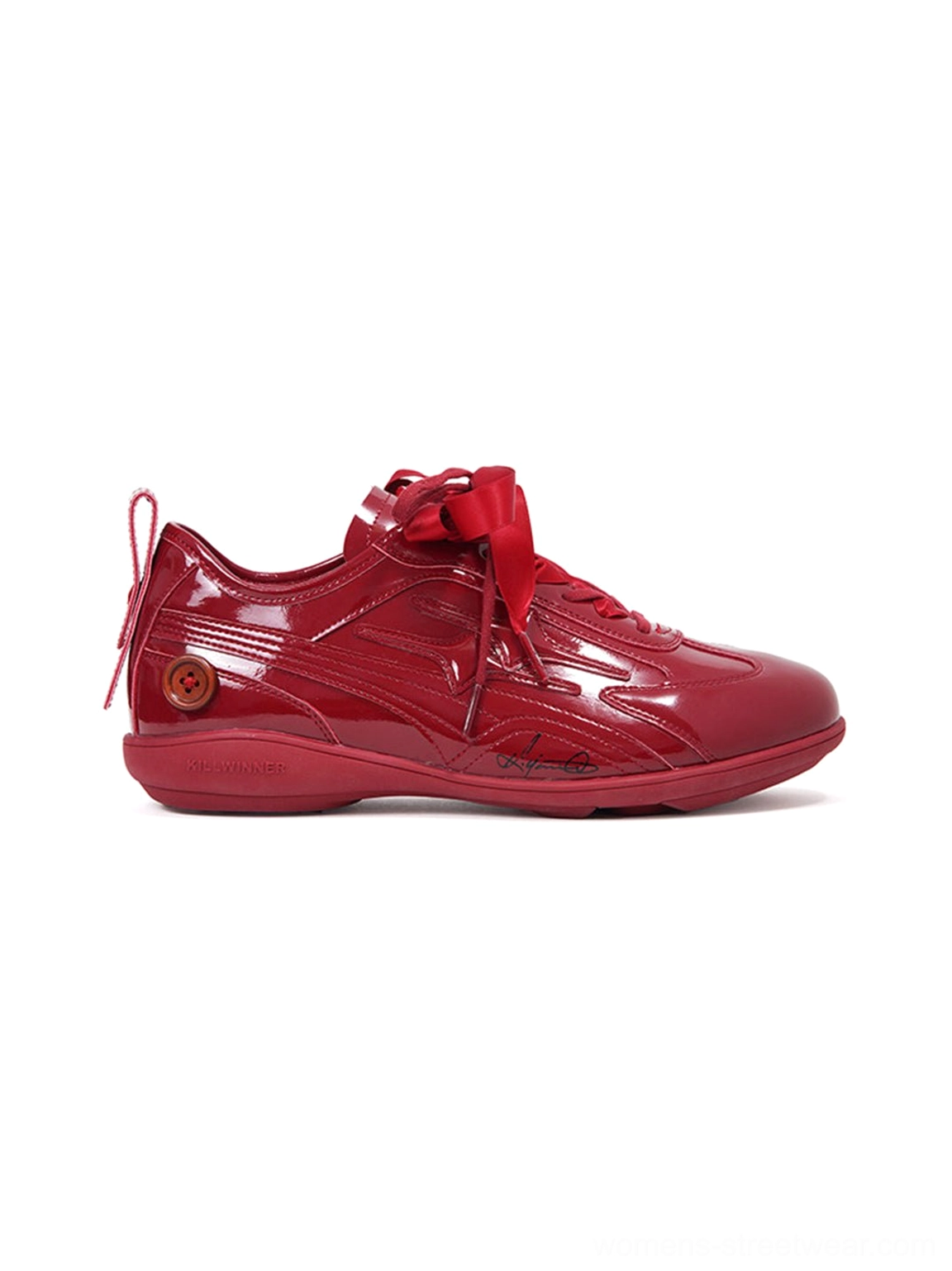 Right rear three-quarter view of crimson red gloss runner sneakers showing heel detail ribbon laces and side panels