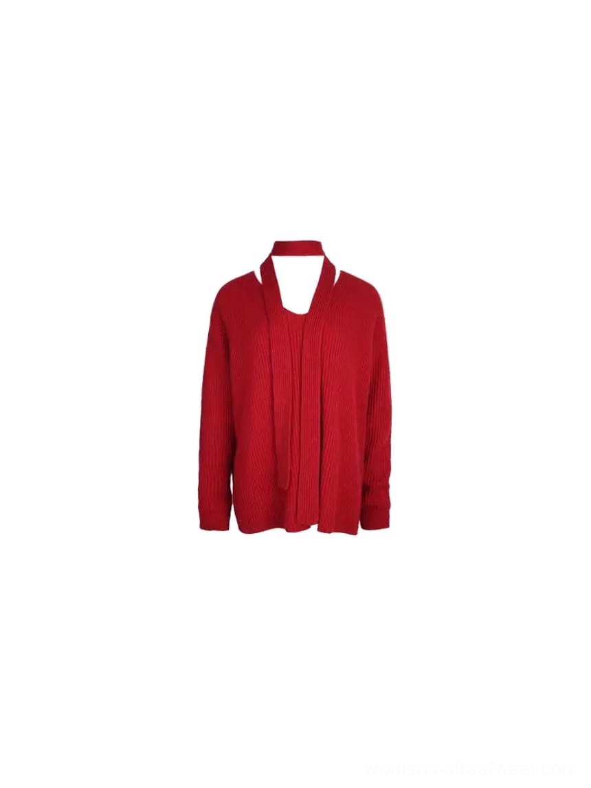 Flat lay of crimson red ribbed V-neck sweater featuring vertical knit texture and matching skinny scarf tie