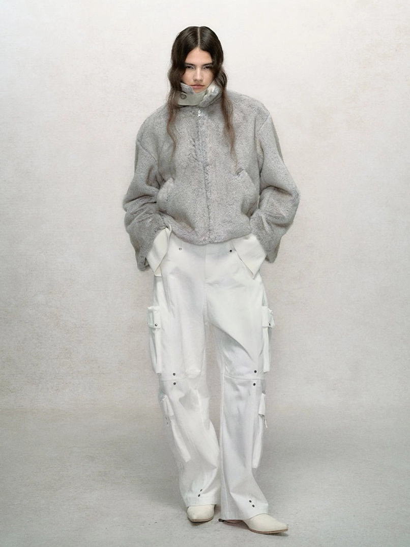 Cropped faux fur winter bomber jacket with plush texture, stand collar, zip front, relaxed sleeves, and modern streetwear silhouette