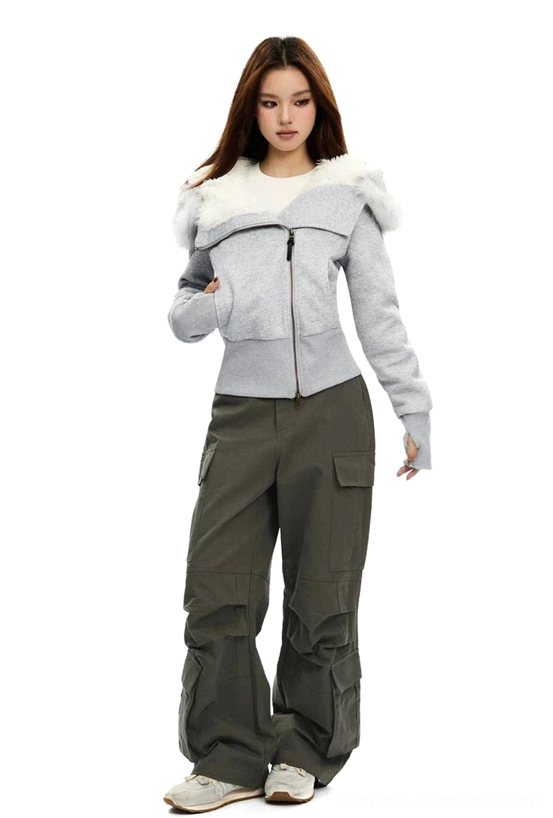 Side-front view of a cropped Light Grey faux-fur hood zip-up hoodie with asymmetrical styling and contemporary streetwear proportions
