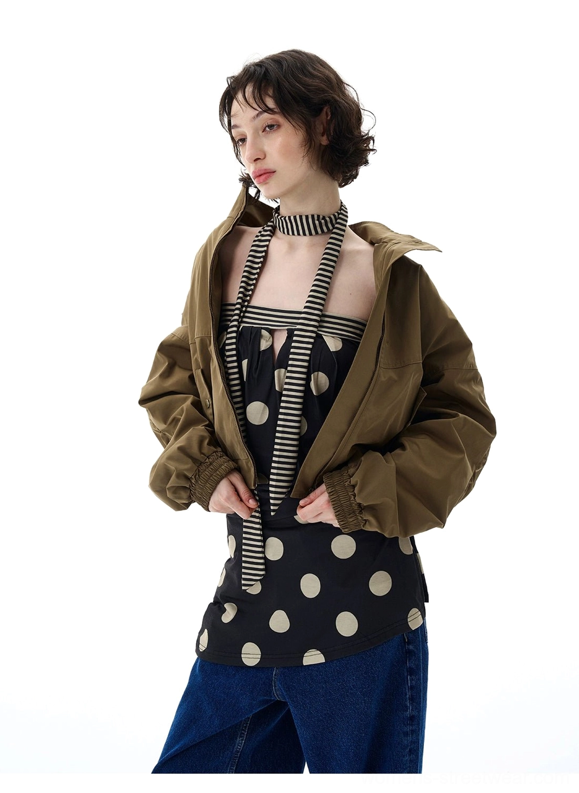 Fashion streetwear outerwear featuring a cropped olive green bomber jacket with epaulets, snap pockets, and elastic waist