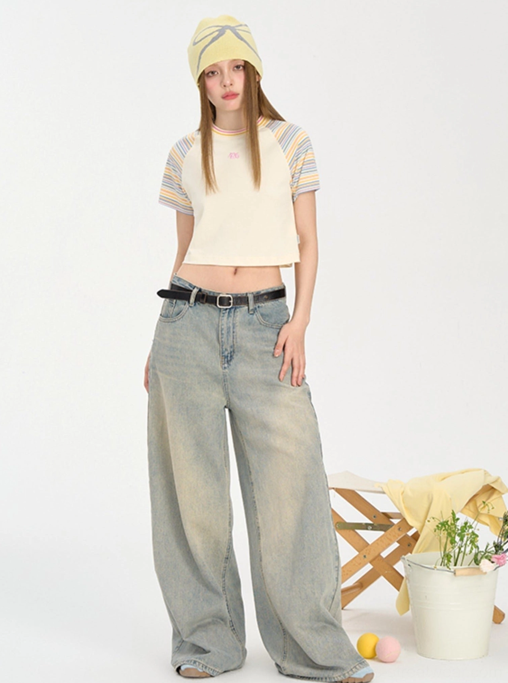 Yellow cropped striped raglan baby tee styled with baggy jeans in a playful Seoul streetwear look