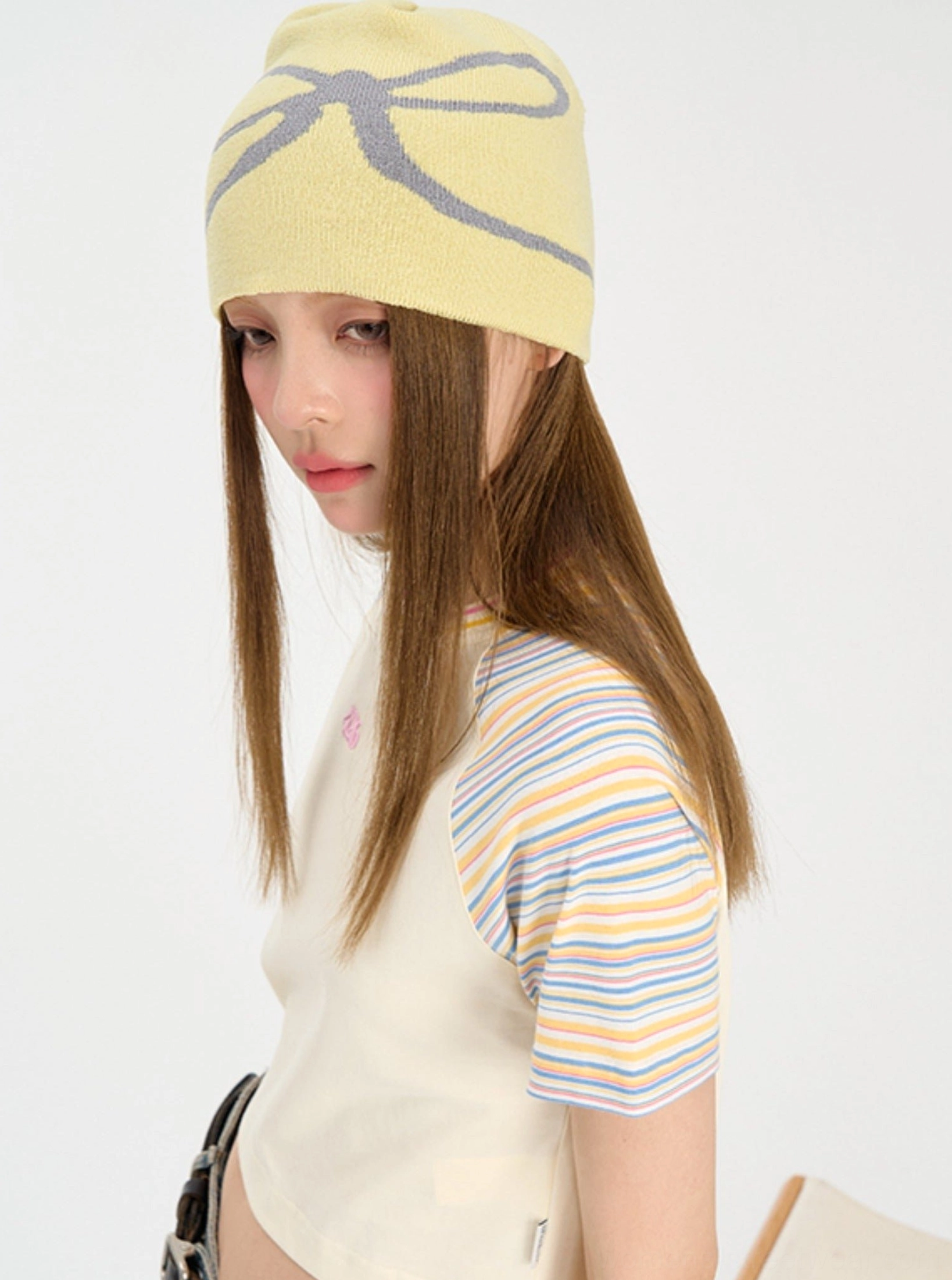 Side view of yellow cropped rainbow stripe raglan baby tee showing fitted Y2K silhouette