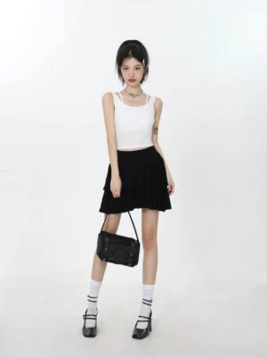 White cross strap cropped camisole styled with a black ruffle mini skirt, Mary Jane shoes, socks, and shoulder bag in a Korean streetwear outfit