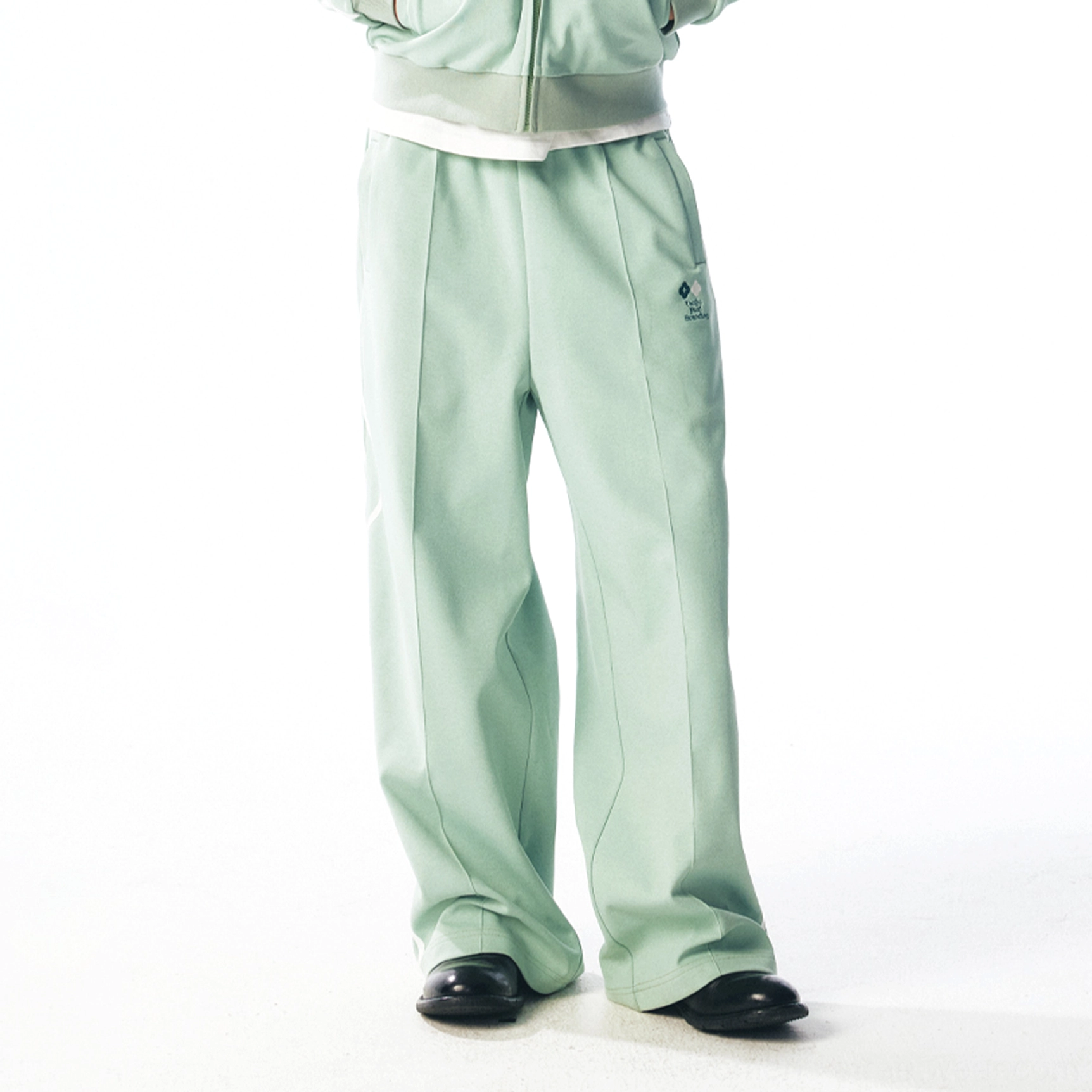 Mint green curved stripe quick-dry track pants with relaxed wide-leg streetwear fit and adjustable hem