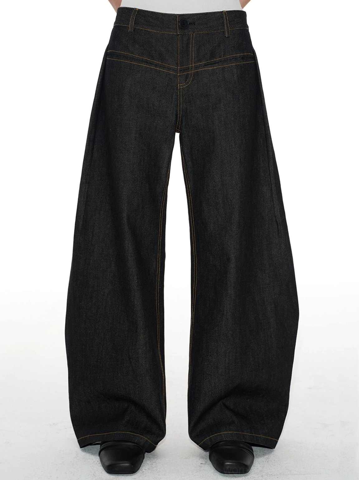 Cropped front view of curved wide-leg raw denim jeans with decorative yoke stitching and dark indigo finish