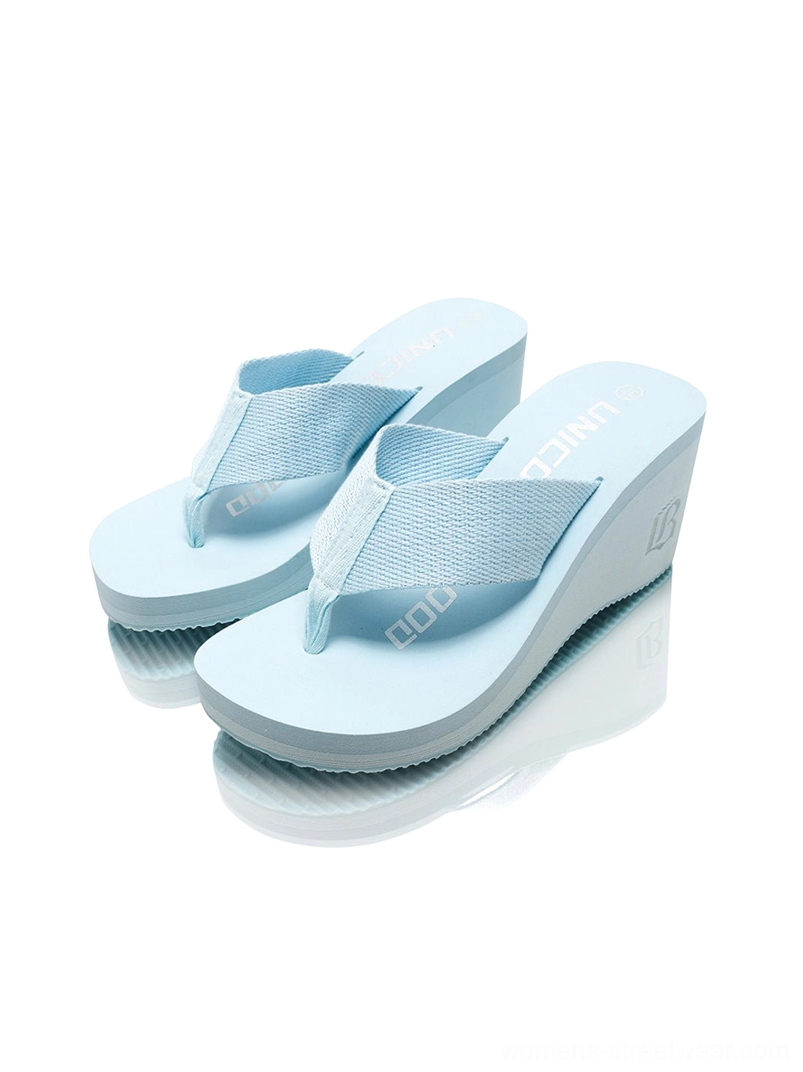Pair of light blue cushioned wedge platform flip-flops viewed from above with textured thong straps and platform soles