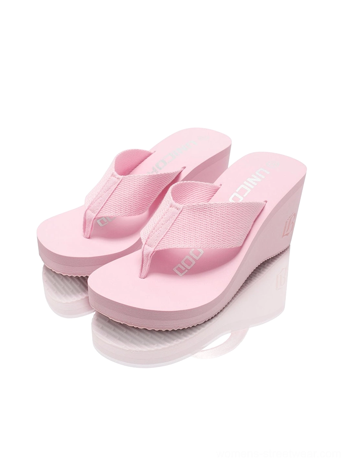 Pair of light pink cushioned wedge platform flip-flops viewed from above with textured toe straps and printed footbeds