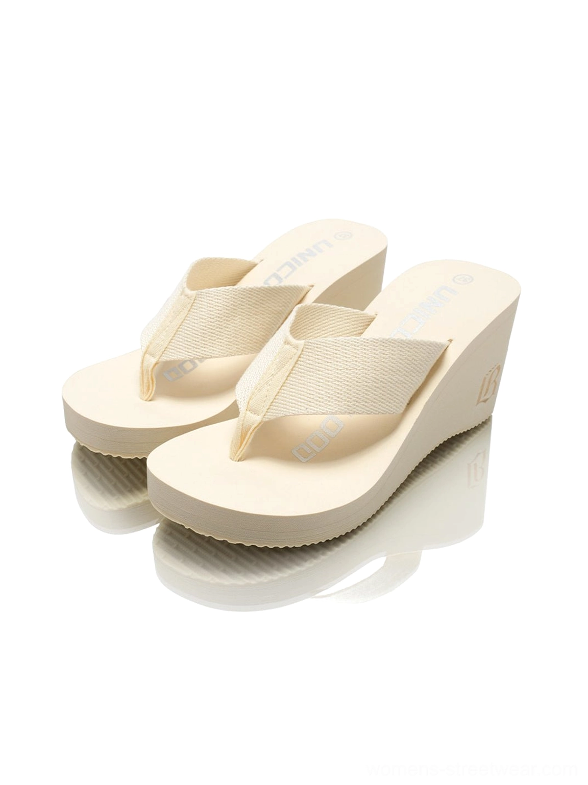 White cushioned wedge platform flip-flops for women with open toe, wide thong strap, and clean minimalist finish